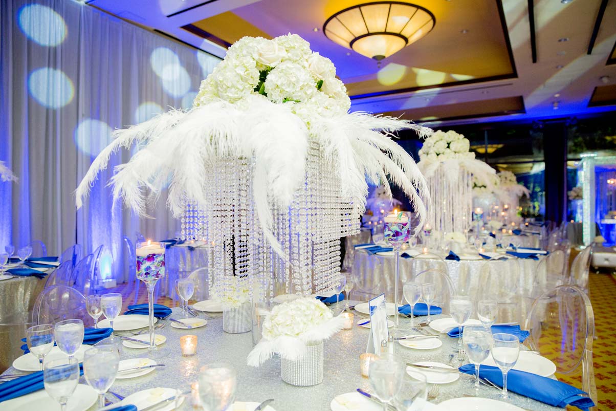 fresh-flowers-white-feathers-glass-crystals-beads-party-table-setting